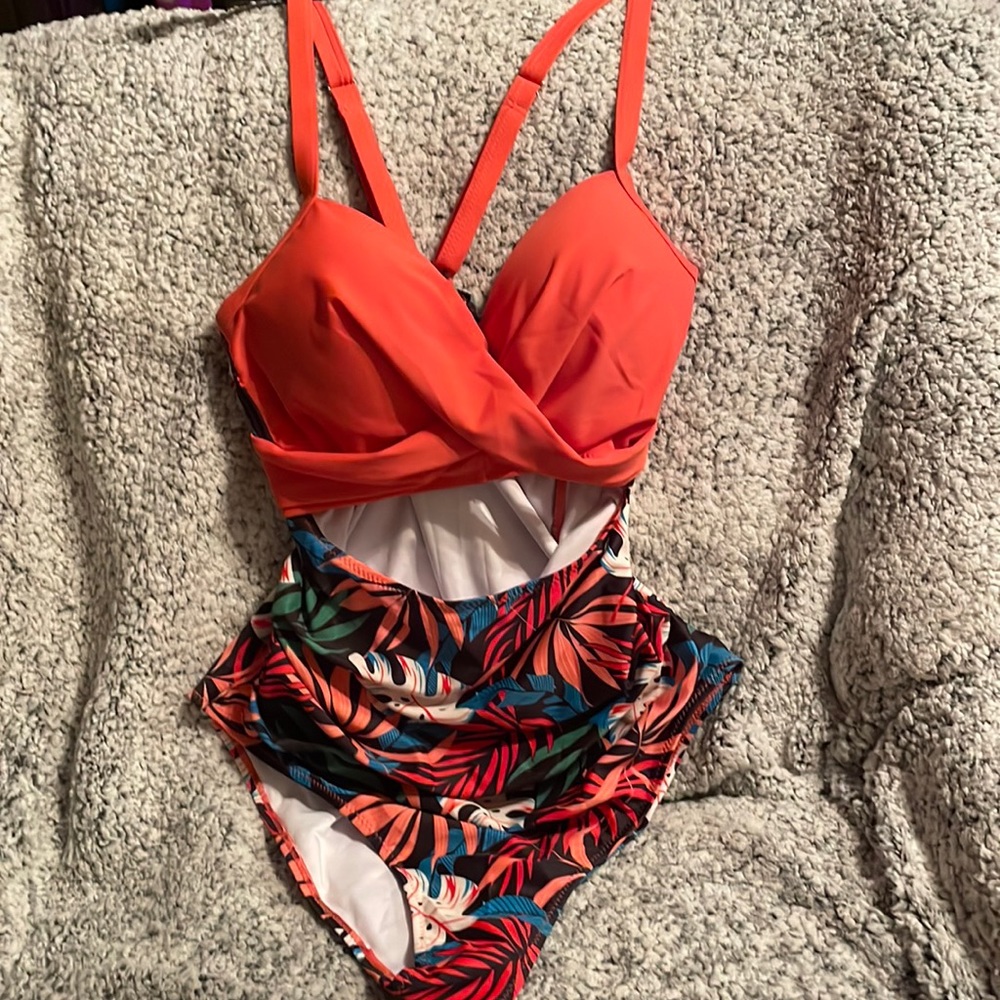 New 1 piece swimsuit peachy color on top with open area under breast, floral btm